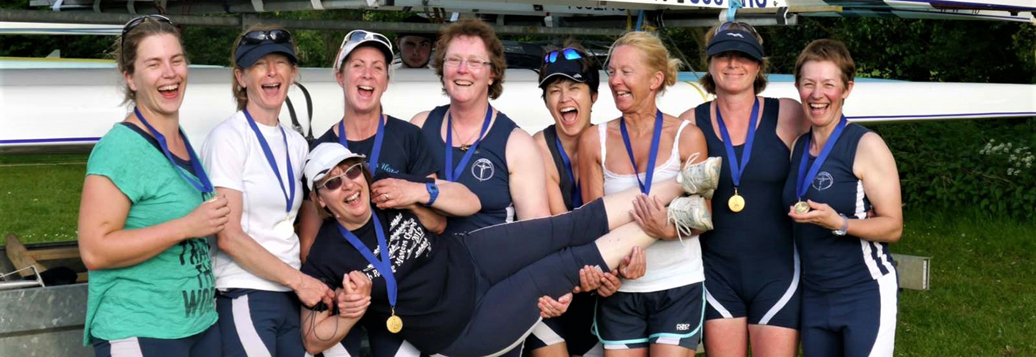 happy rowers holding cox