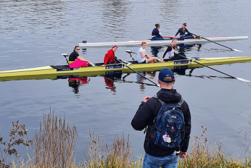 Crew listening to coach on bank