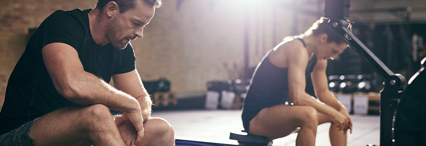 2 rowers catching their breath after indoor session