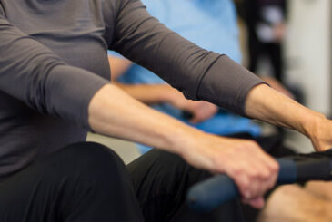 hands pulling indoor rowing machine