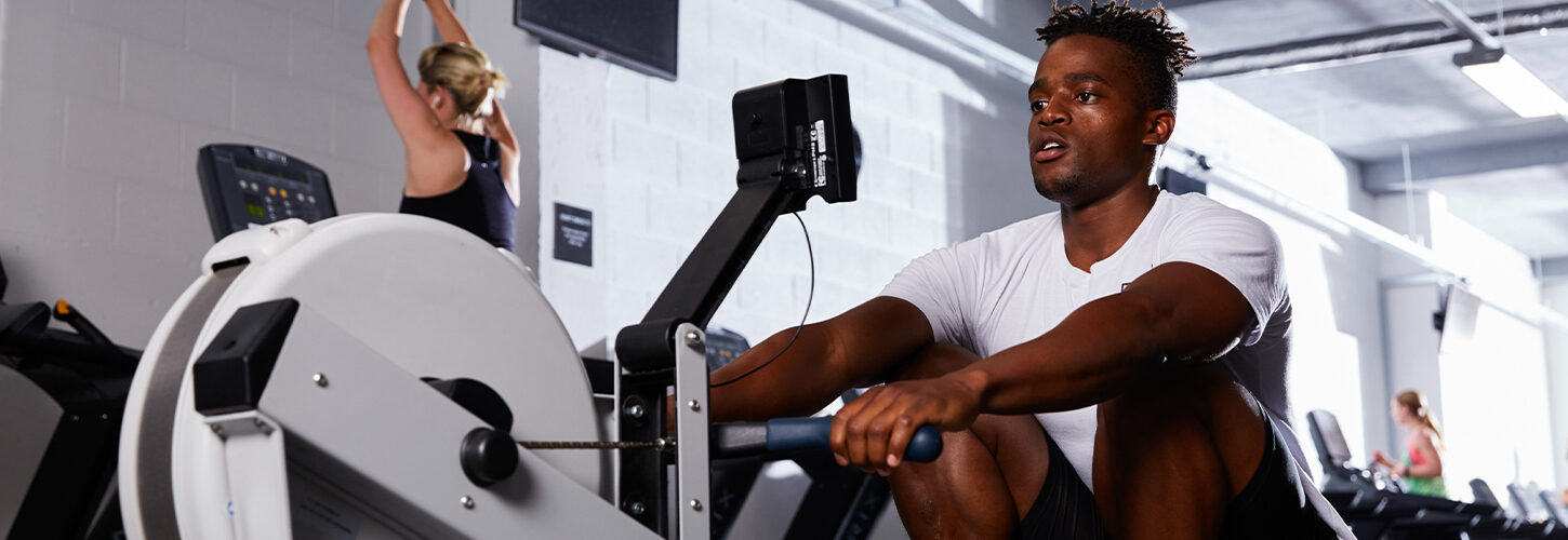Man at catch on indoor rower