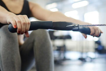 Woman at catch on indoor rower
