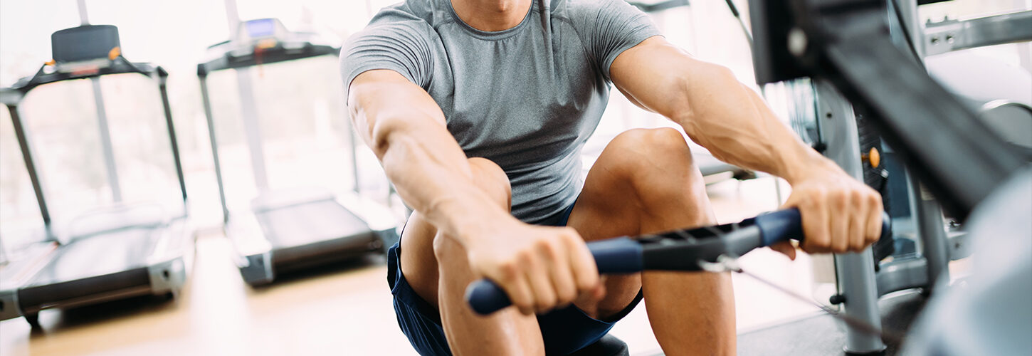 Rower in indoor machine at gym