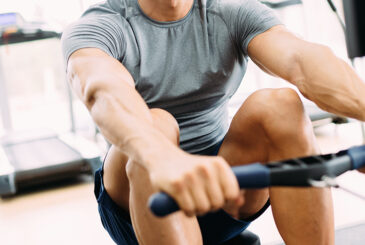 Rower in indoor machine at gym