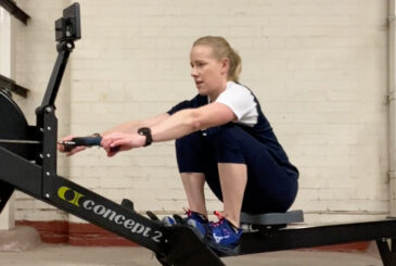 Athlete on rowing machine with hips fully compressed