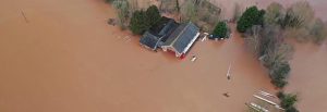 Ross RC boathouse surrounded by muddy water