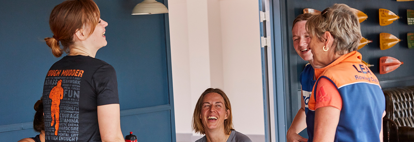 rowers and coach laughing