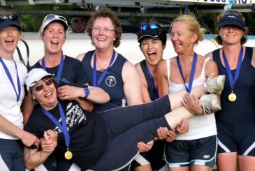happy rowers holding cox