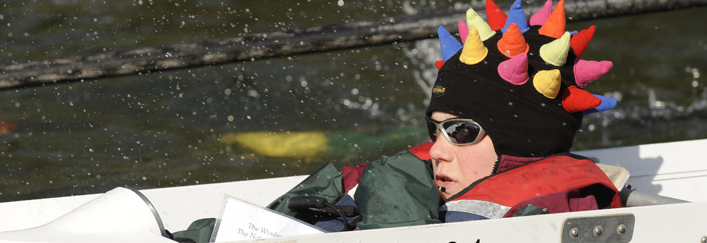 Cox in hat with coloured spikes in front loader