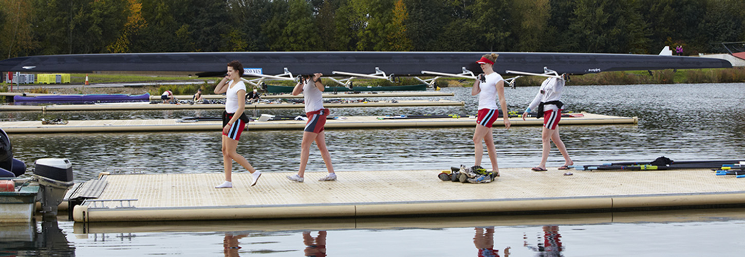Carrying boat off landing stage