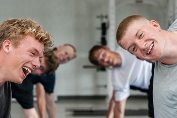 young men doing core in gym
