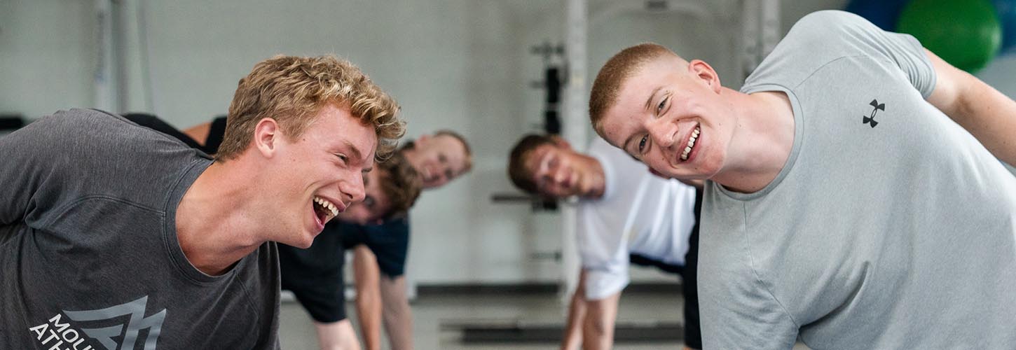 young men doing core in gym
