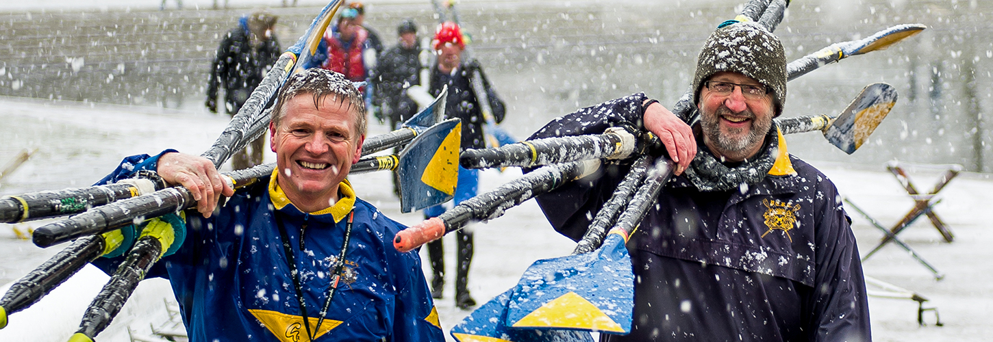 rowers carrying blades in snow
