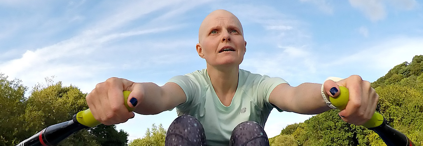 woman rowing during chemo with bald head