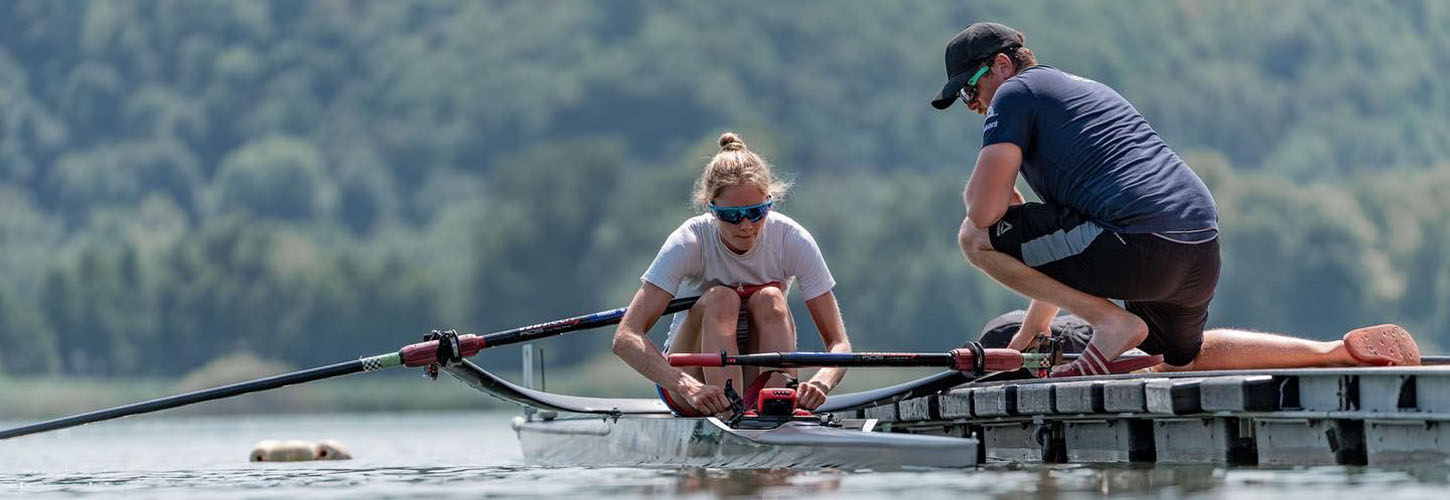 sculler and coach on landing stage
