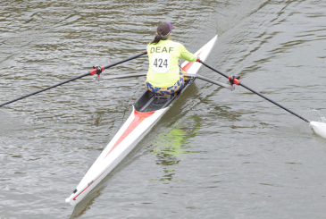 Sculler with hearing impairment with DEAF on back of shirt