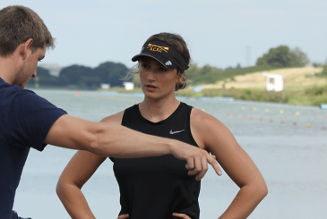 Coach having 1-1 discussion with rower on landing stage