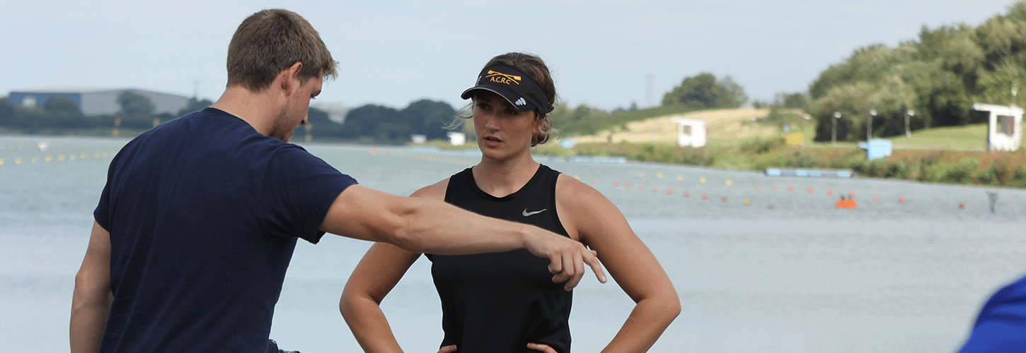 Coach having 1-1 discussion with rower on landing stage