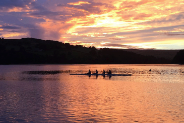 A crew cooling down on the water in sunset