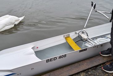 Cox in ski trousers next to front loader with camping mat inserted in bows