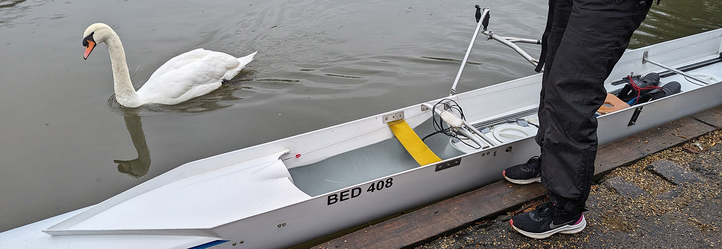 Cox in ski trousers next to front loader with camping mat inserted in bows