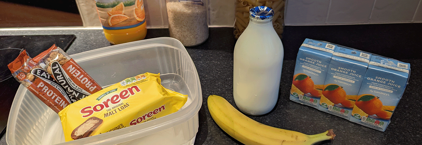 Malt loaf, cereal bars, milk, banana and orange juice