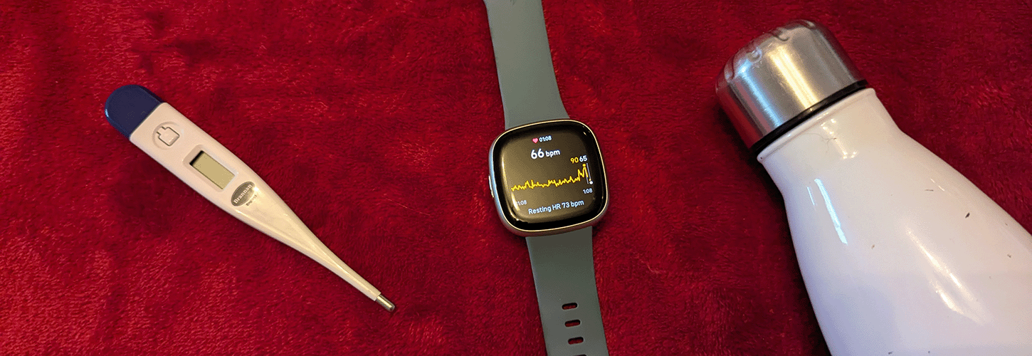 Thermometer, watch showing heart rate, and water bottle