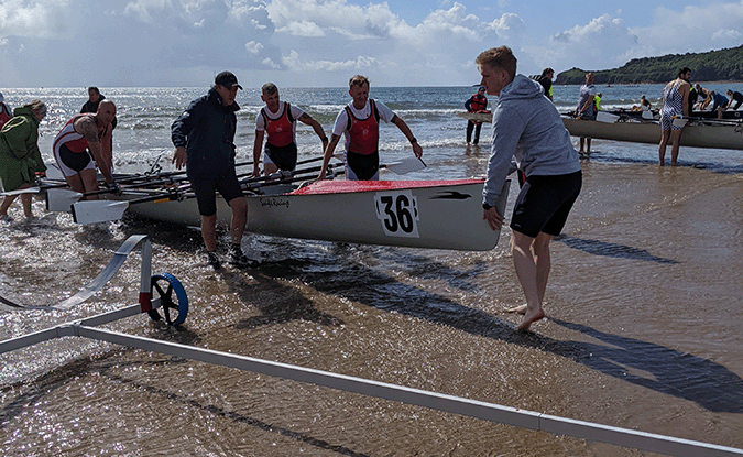 Coastal boat being recovered onto trolley