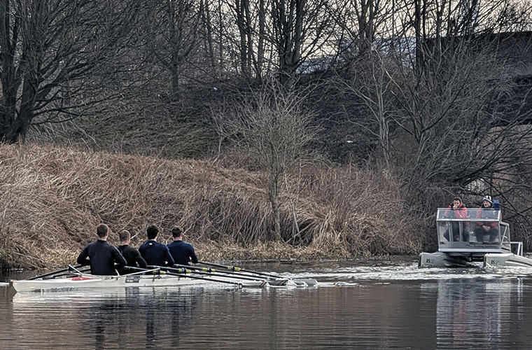 quad with coach on water in winter